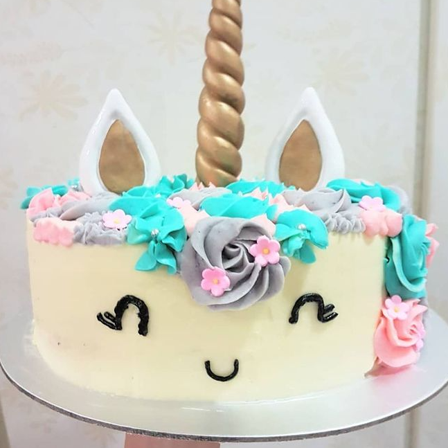 Customised Unicorn Cake decorated with blue, pink and grey flowers